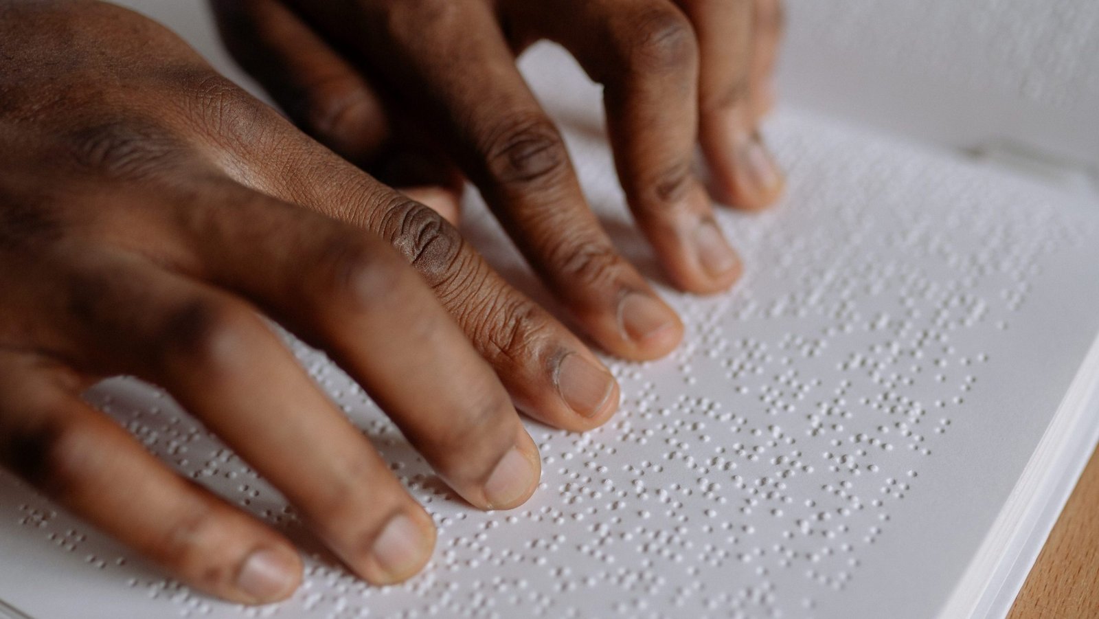 A male hand making use of brail.
